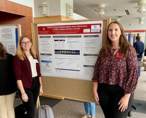 NeuroLAND Lab Director, Dr. Haley Dresang (left), visits the poster presentation of Ellie McCreary (right), a speech-language pathology MS student.